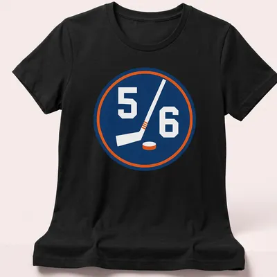 Hockey-themed shirt with a 5/6 emblem featuring a stick and puck in navy, white, and orange — printed on a women's shirt