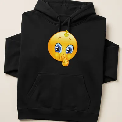 Cartoon baby emoji with shushing face in yellow, blue, black, and white — printed on a unisex hoodie