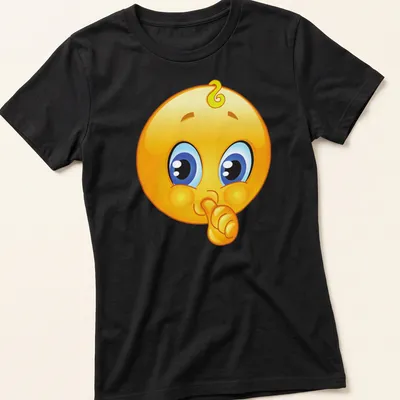 Cartoon baby emoji with shushing face in yellow, blue, black, and white — printed on a women's shirt