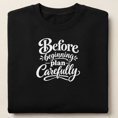 Hand-lettered script saying 'Before beginning plan Carefully' in black text — printed on a unisex sweatshirt