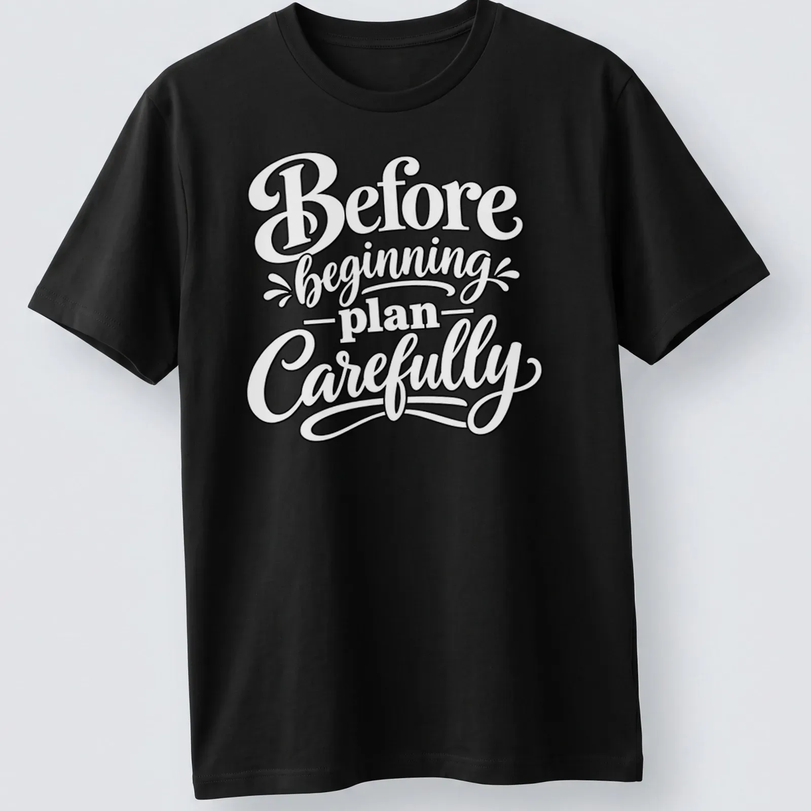 Hand-lettered script saying 'Before beginning plan Carefully' in black text — printed on a unisex t-shirt