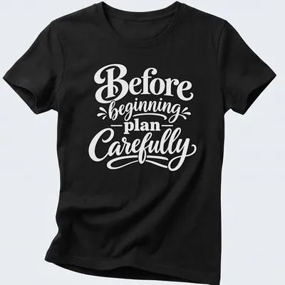 Hand-lettered script saying 'Before beginning plan Carefully' in black text — printed on a women's shirt