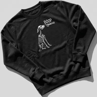 Playful Halloween design featuring a dog skeleton with the word Boop above — printed on a unisex sweatshirt