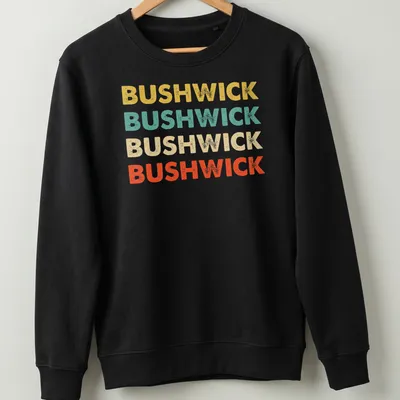 Retro typography shirt featuring the word BUSHWICK in bold colors. — printed on a unisex sweatshirt