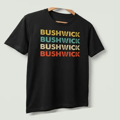 Retro typography shirt featuring the word BUSHWICK in bold colors. — printed on a unisex t-shirt (angled view)
