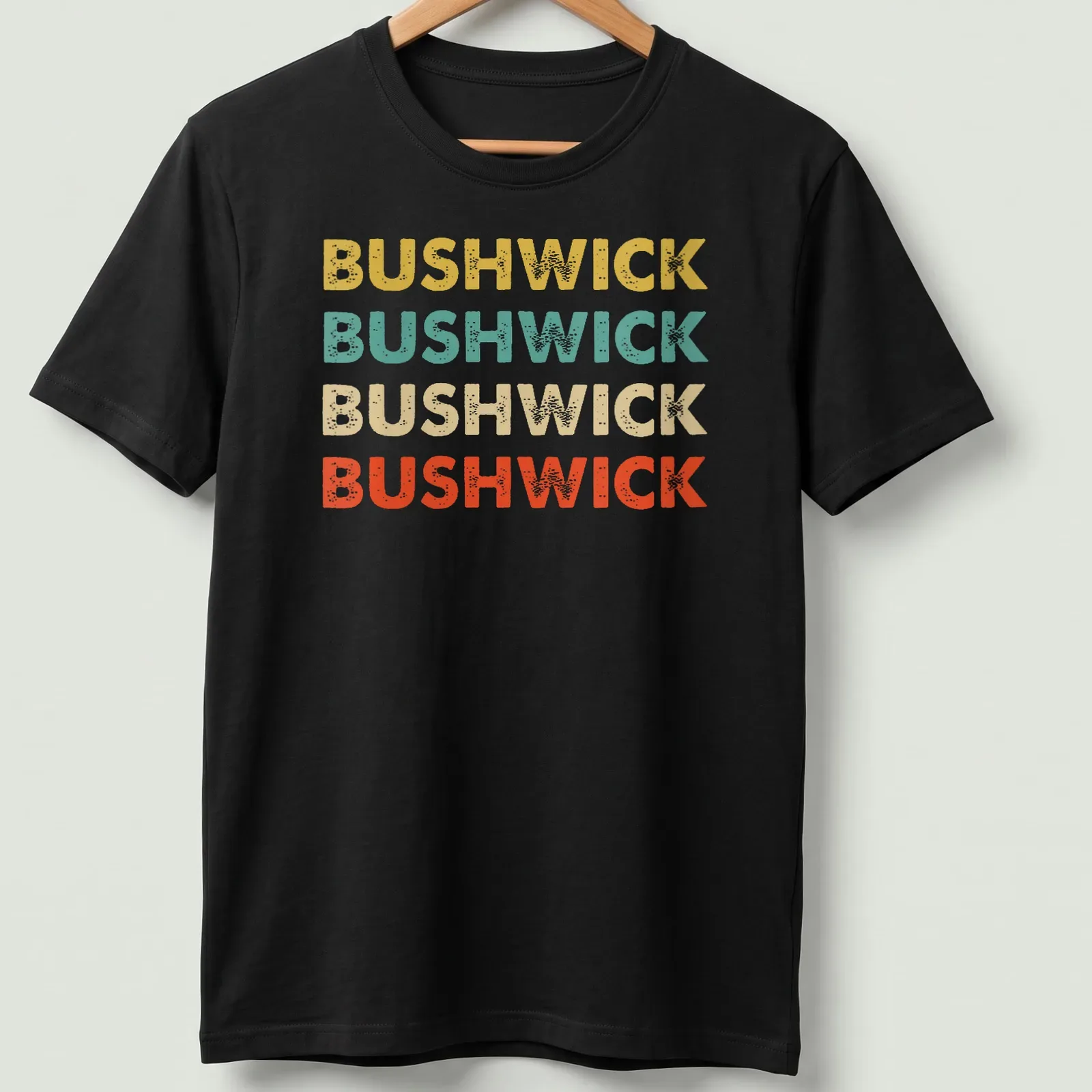 Retro typography shirt featuring the word BUSHWICK in bold colors. — printed on a unisex t-shirt