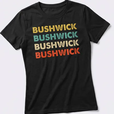 Retro typography shirt featuring the word BUSHWICK in bold colors. — printed on a women's shirt