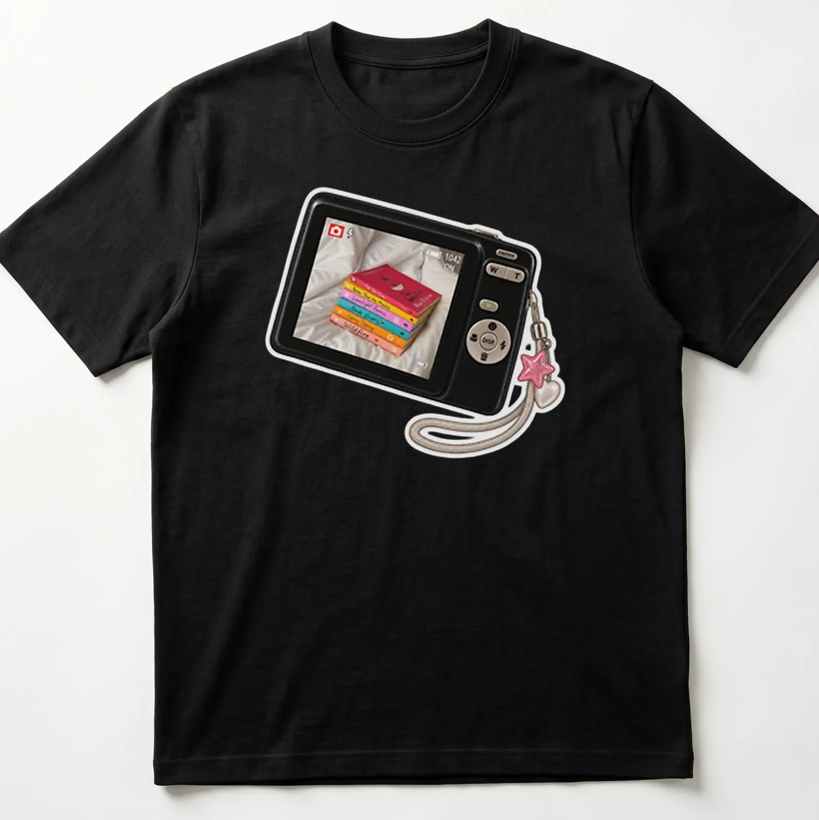 Realistic print of a camera surrounded by colorful books with the text Camera Picture Of Books — printed on a unisex t-shirt