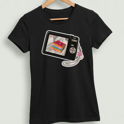 Realistic print of a camera surrounded by colorful books with the text Camera Picture Of Books — printed on a women's shirt