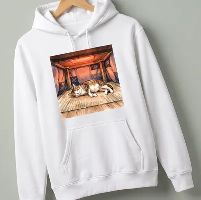 Watercolor print of a tabby cat napping under a kotatsu with the text above. — printed on a unisex hoodie