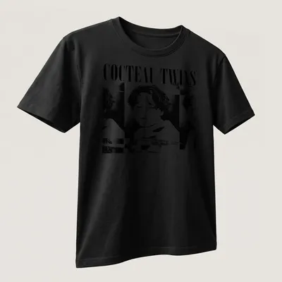 Black and white portrait of a woman with Cocteau Twins text above — printed on a unisex t-shirt (angled view)