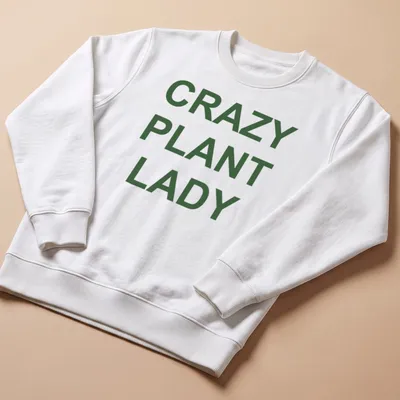 Bold typography CRAZY PLANT LADY shirt with green text on white background — printed on a unisex sweatshirt