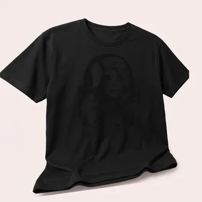 Vintage pencil drawing of Dolly Parton in black and white — printed on a unisex t-shirt (angled view)