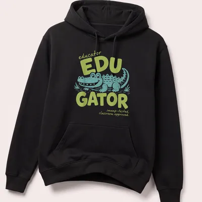 Playful cartoon alligator with text about educators in light green and teal — printed on a unisex hoodie