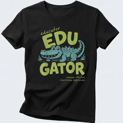 Playful cartoon alligator with text about educators in light green and teal — printed on a women's shirt
