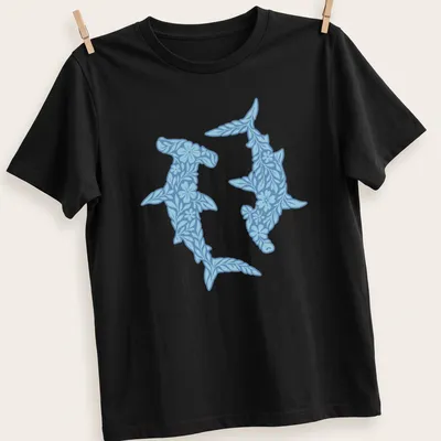 Illustration of floral hammerhead sharks in light and dark blue with white accents — printed on a unisex t-shirt