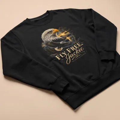 Detailed illustration of a bald eagle with golden feathers and blue sky backdrop. — printed on a unisex sweatshirt