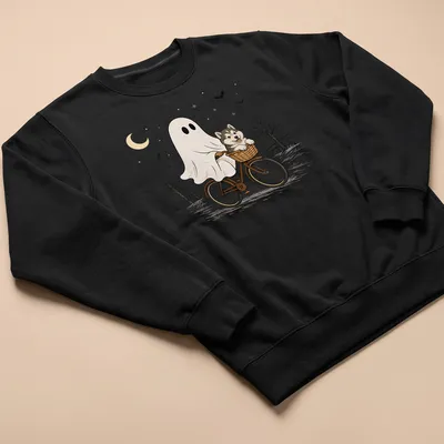 Cartoon of an Alaskan Malamute riding a bicycle, with Halloween themes — printed on a unisex sweatshirt