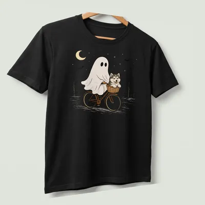 Cartoon of an Alaskan Malamute riding a bicycle, with Halloween themes — printed on a unisex t-shirt (angled view)