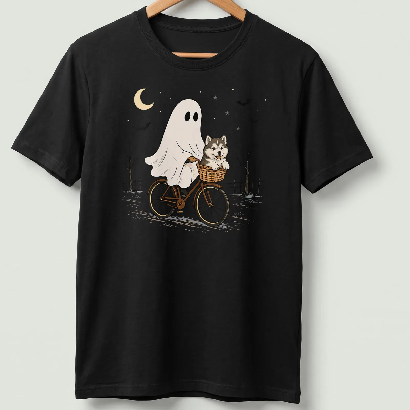 Cartoon of an Alaskan Malamute riding a bicycle, with Halloween themes — printed on a unisex t-shirt