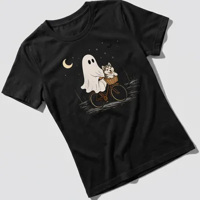 Cartoon of an Alaskan Malamute riding a bicycle, with Halloween themes — printed on a women's shirt