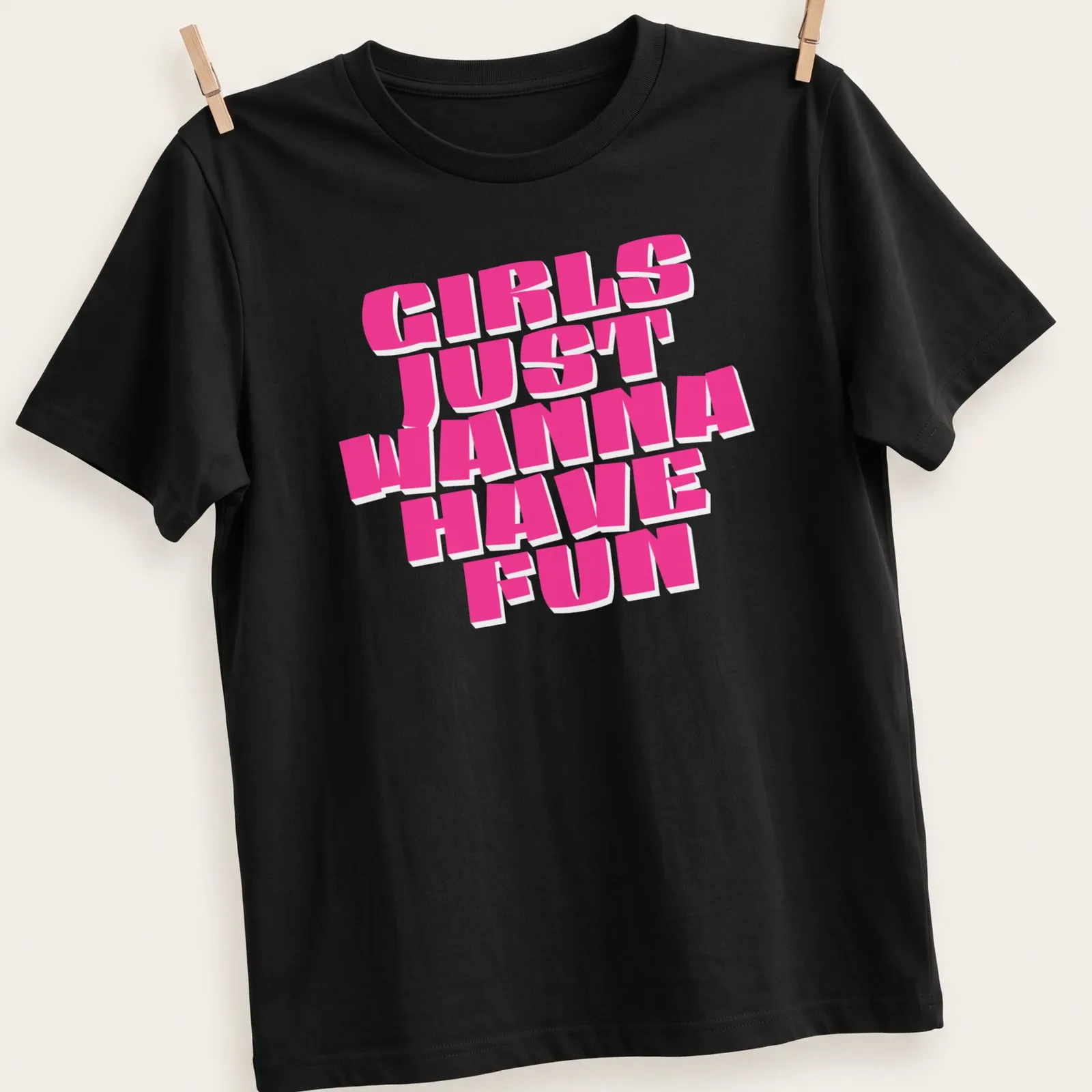 Bold pink typography shirt with the phrase 'Girls Just Wanna Have Fun' — printed on a unisex t-shirt