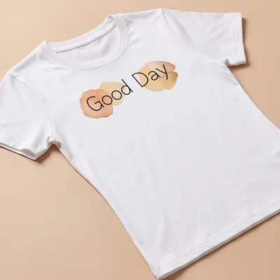 Minimalist t-shirt featuring watercolor circles and the words Good Day in soft colors — printed on a women's shirt