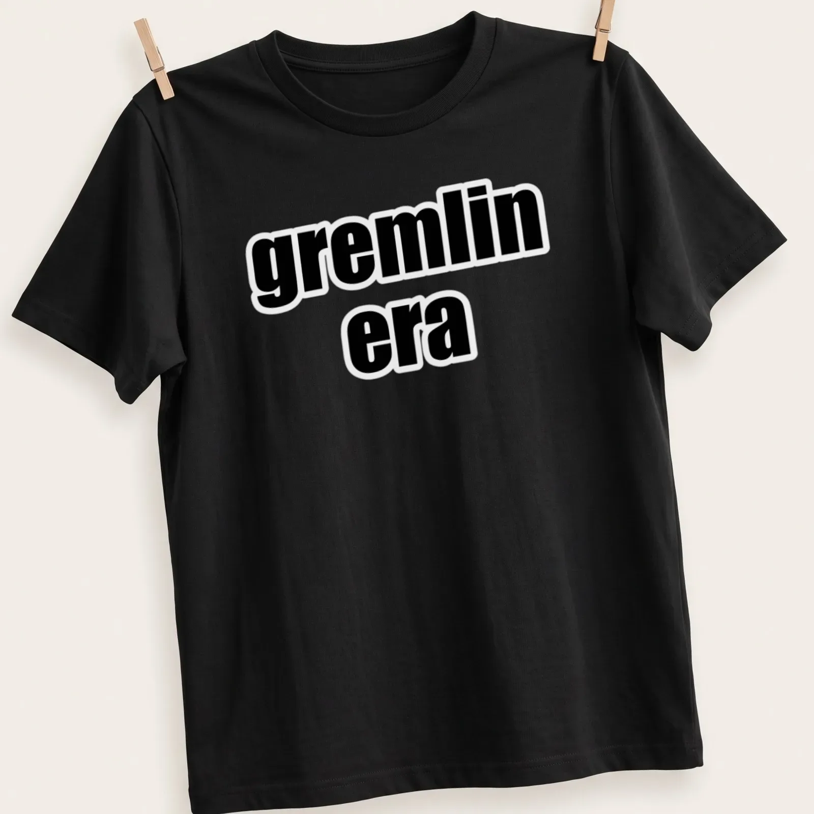 Bold text t-shirt featuring the phrase 'gremlin era' in black and white — printed on a unisex t-shirt