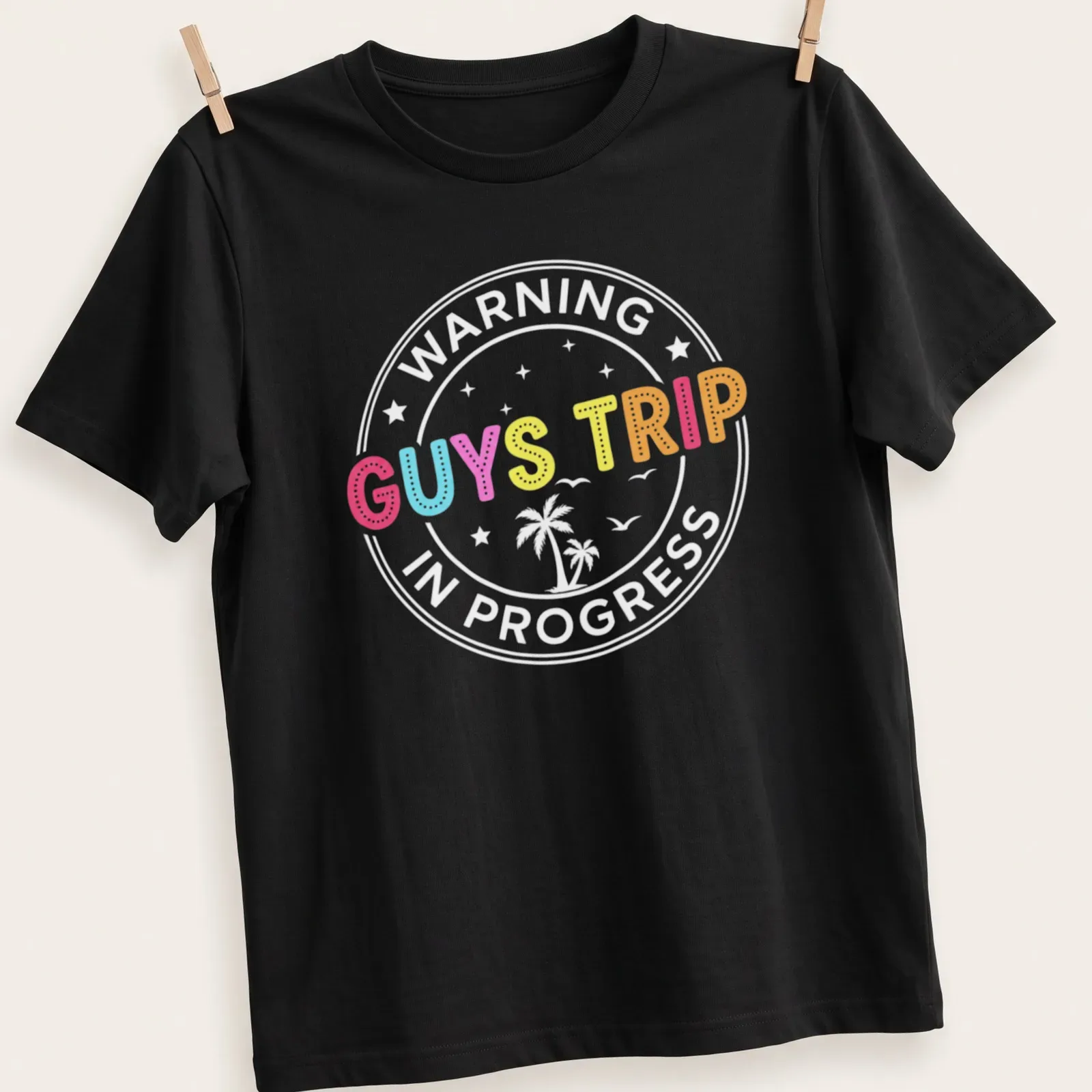 Colorful illustration of tropical vacation elements with 'GUYS TRIP' text — printed on a unisex t-shirt