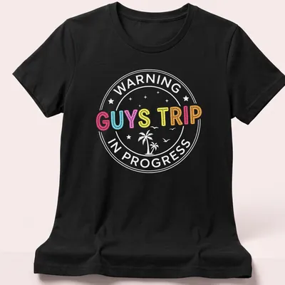 Colorful illustration of tropical vacation elements with 'GUYS TRIP' text — printed on a women's shirt