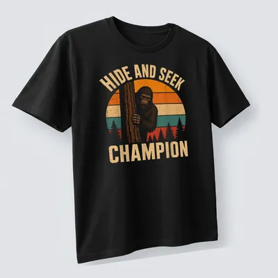 Retro vintage Bigfoot Sasquatch t-shirt with playful text above cartoon art — printed on a unisex t-shirt (angled view)