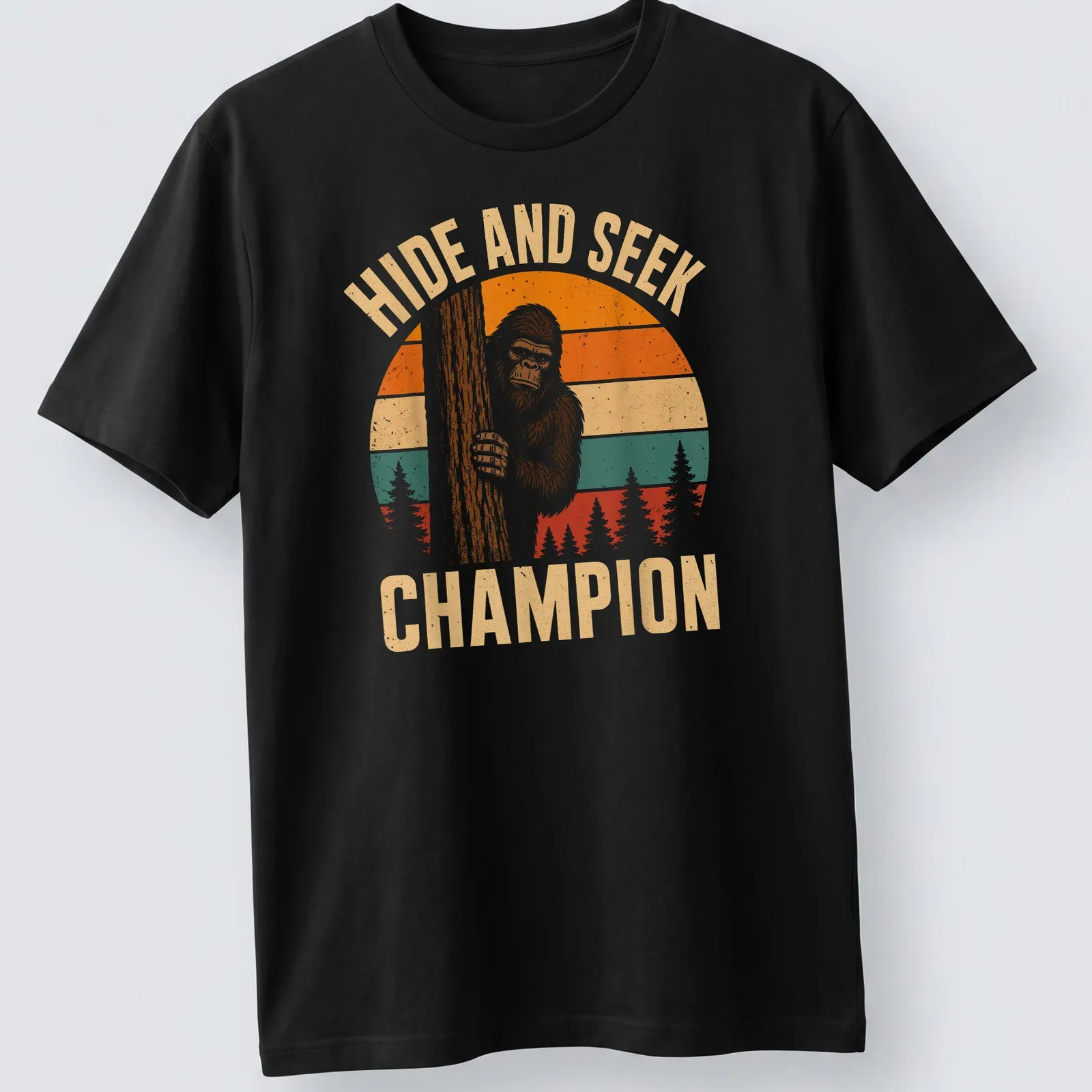 Retro vintage Bigfoot Sasquatch t-shirt with playful text above cartoon art — printed on a unisex t-shirt