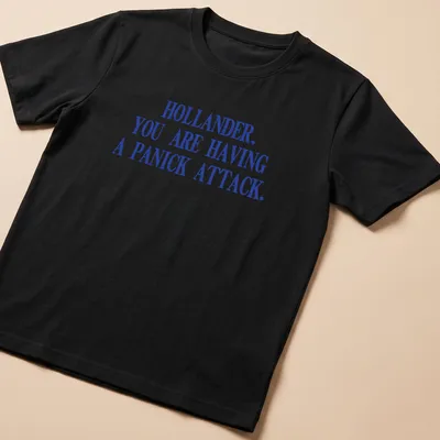 Bold distressed shirt with the text 'HOLLANDER, YOU ARE HAVING A PANICK ATTACK.' in blue and white.
