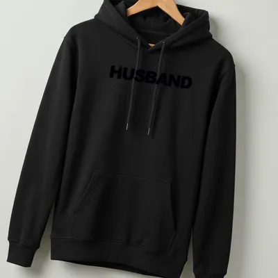 Minimal bold black HUSBAND text on a — printed on a unisex hoodie