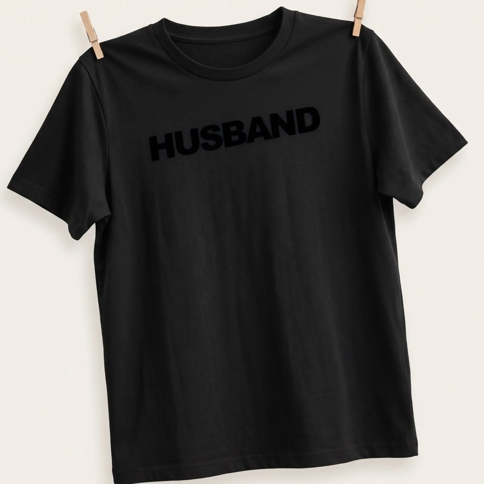 Minimal bold black HUSBAND text on a — printed on a unisex t-shirt
