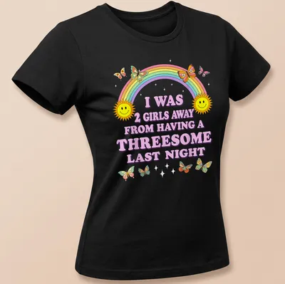 Colorful cartoon shirt with smiling suns, butterflies, and humorous text — printed on a women's shirt