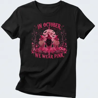 Vintage illustration of three witches with the text 'In October We Wear Pink' — printed on a women's shirt