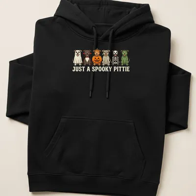 Cartoon Pitbulls in Halloween costumes with the text 'Just A Spooky Pittie' — printed on a unisex hoodie