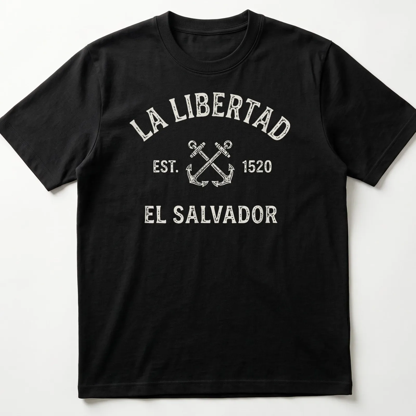 Vintage design featuring crossed anchors and text honoring La Libertad, El Salvador. — printed on a unisex t-shirt
