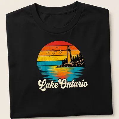 Retro sunset scene featuring a lighthouse with seagulls and the text 'Lake Ontario' in stylized lettering — printed on a unisex t-shirt