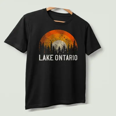 Sunset over trees with Lake Ontario text in vintage retro style — printed on a unisex t-shirt (angled view)
