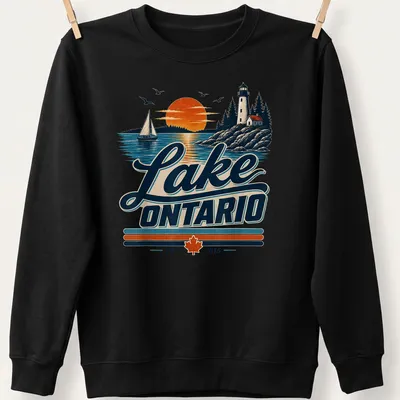 Vintage Lake Ontario Lighthouse and sailboat graphic with sunset colors — printed on a unisex sweatshirt
