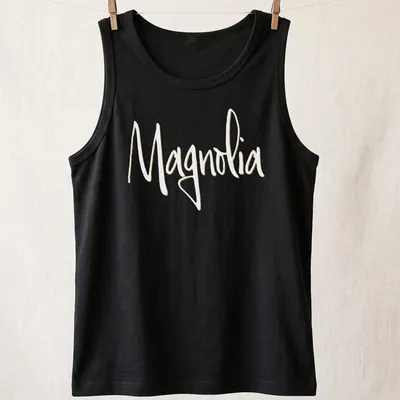 Elegant script reading 'Magnolia' in light yellow on a white background. — printed on a tank top