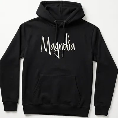 Elegant script reading 'Magnolia' in light yellow on a white background. — printed on a unisex hoodie