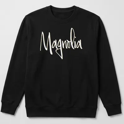 Elegant script reading 'Magnolia' in light yellow on a white background. — printed on a unisex sweatshirt