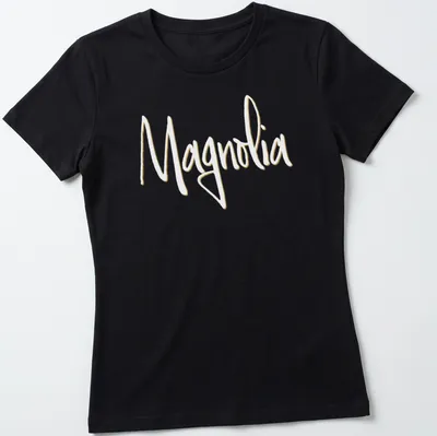 Elegant script reading 'Magnolia' in light yellow on a white background. — printed on a women's shirt