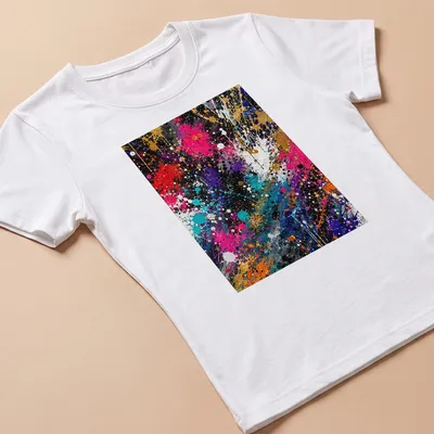 Colorful splatter art T-shirt in black, gold, pink, red, blue, and white — printed on a women's shirt
