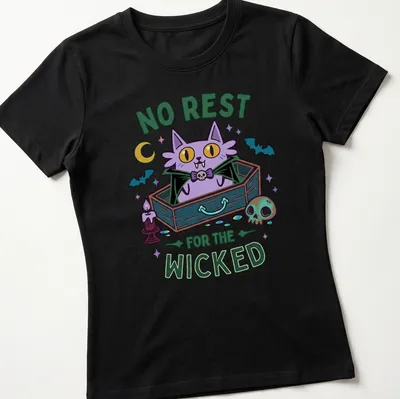 Kawaii style t-shirt featuring a cartoon cat in a coffin with colorful lettering — printed on a women's shirt