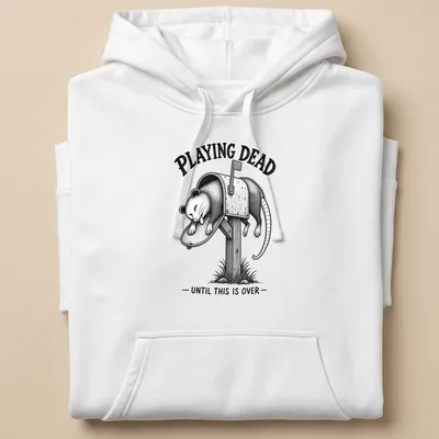 Vintage illustration of a possum with text reading 'PLAYING DEAD UNTIL THIS IS OVER' in black and gray. — printed on a unisex hoodie