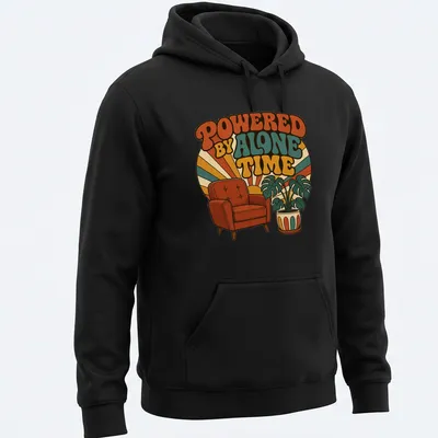 Retro design featuring an armchair and potted plant with the text 'Powered By Alone Time' — printed on a unisex hoodie